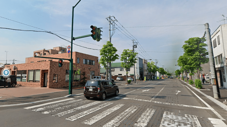 レンガ造りの建物に向かって交差点を渡ります